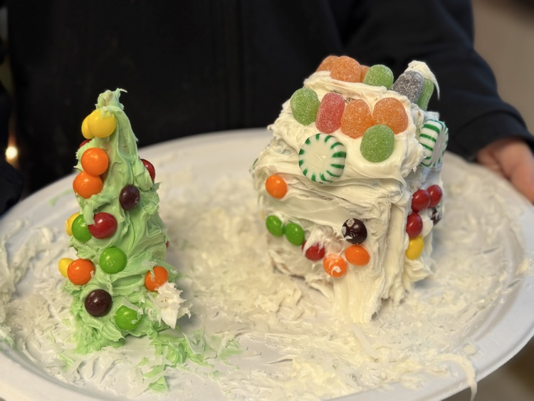students decorating gingerbread houses