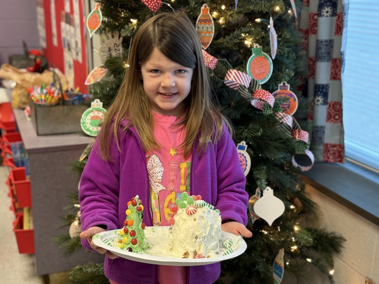 students decorating gingerbread houses