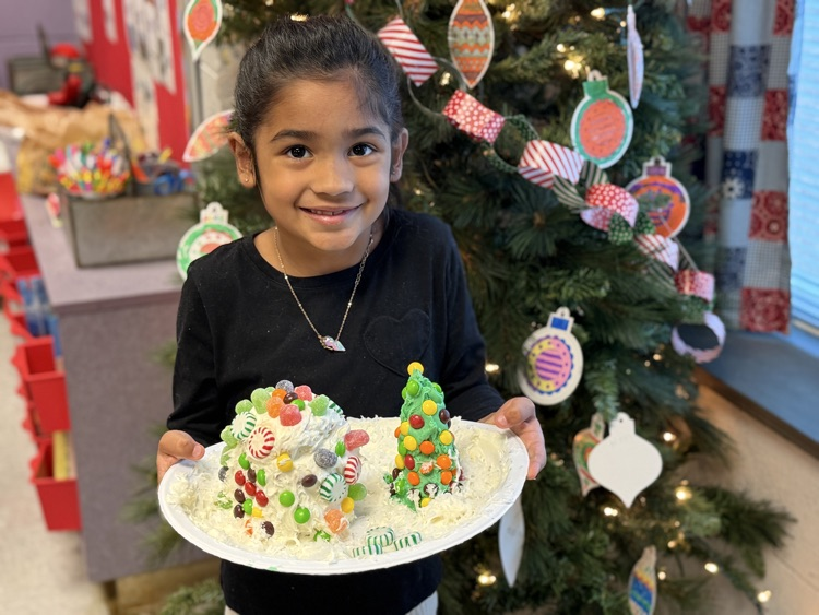 students decorating gingerbread houses