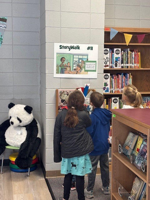 students reading and walking around library