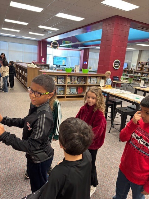 students reading and walking around library