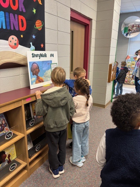 students reading and walking around library