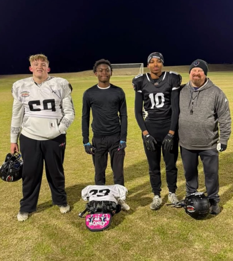 three football players and coach 