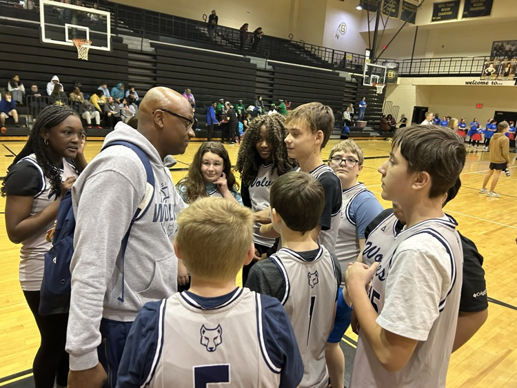 coach and kids at basketball