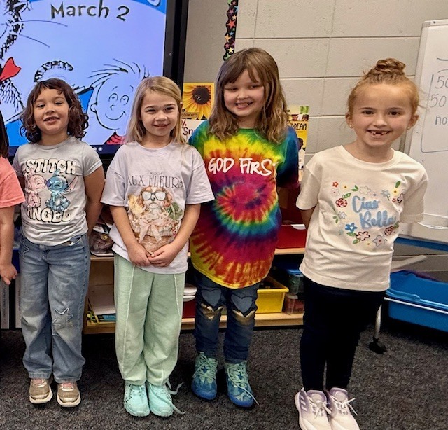 Children wearing t-shirts with text on them