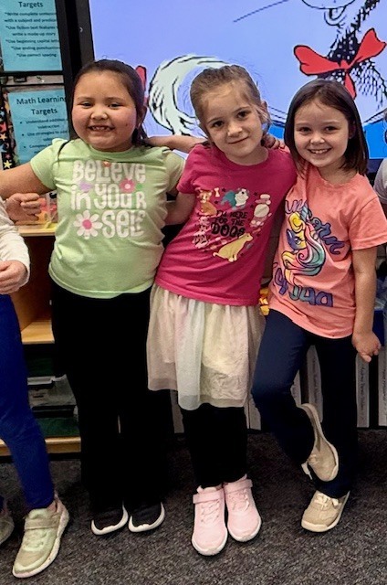Children wearing t-shirts with text on them