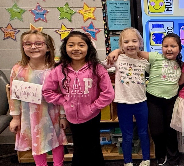 Children wearing t-shirts with text on them