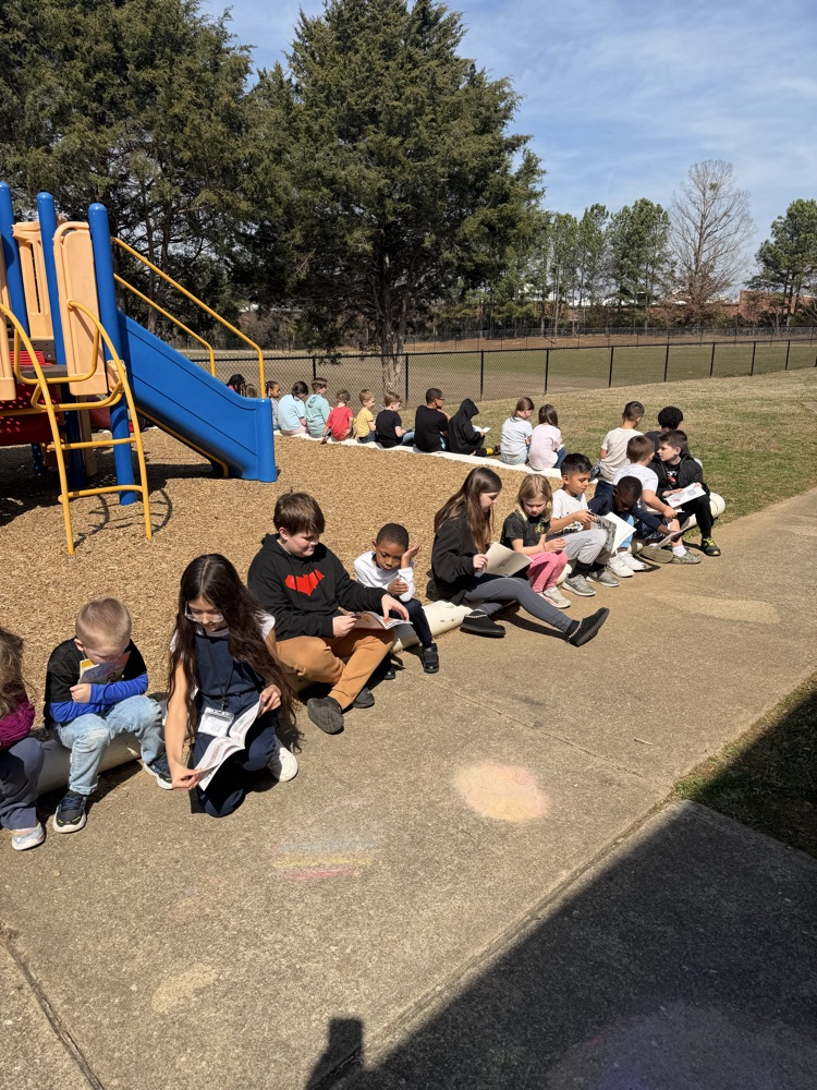 two classes reading together outside 