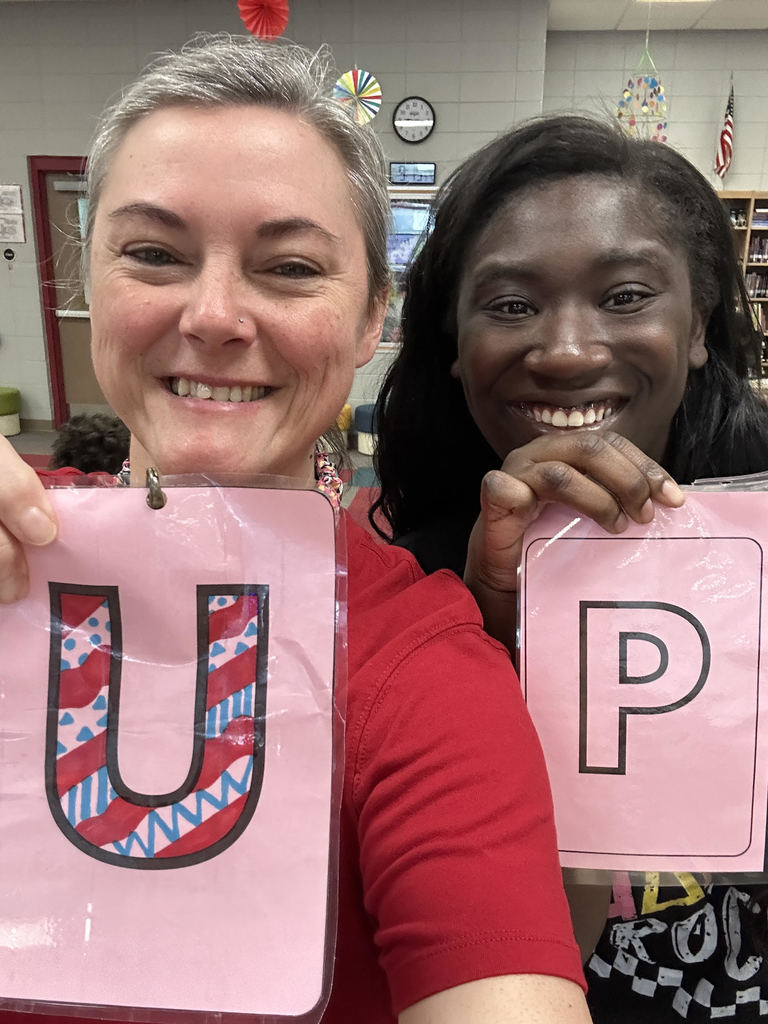 teachers holding scrabble letters