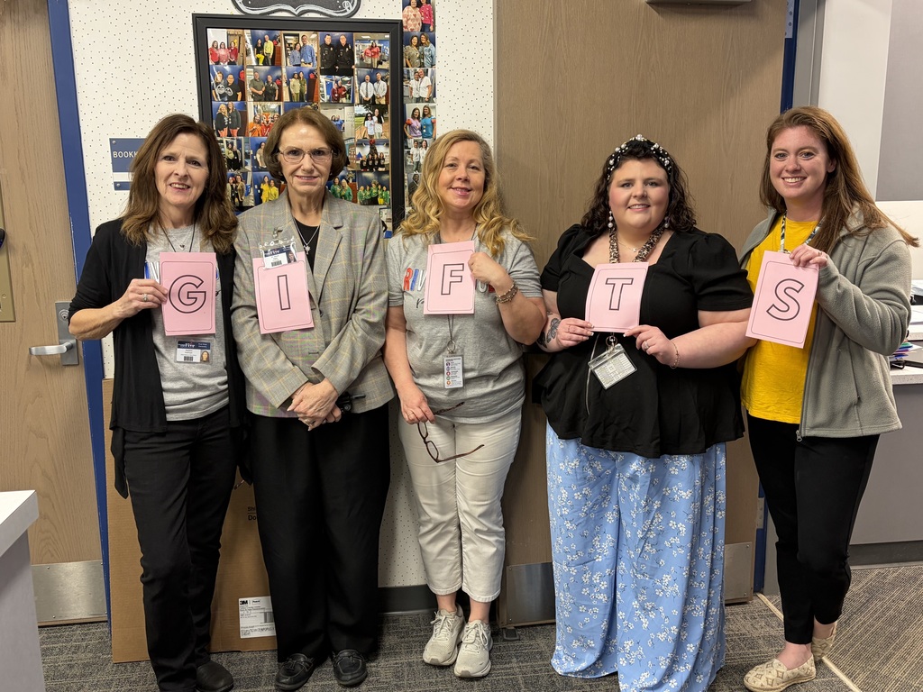 teachers holding scrabble letters