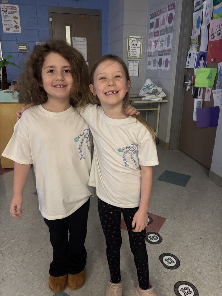 two students wearing the same shirt 
