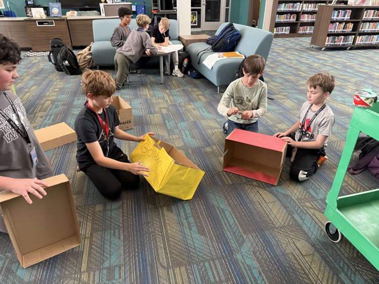 students creating boxes and posters