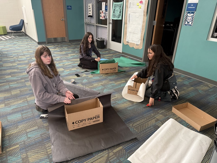 students creating boxes and posters