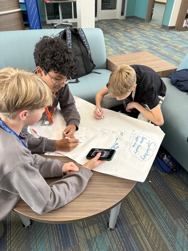 students creating boxes and posters