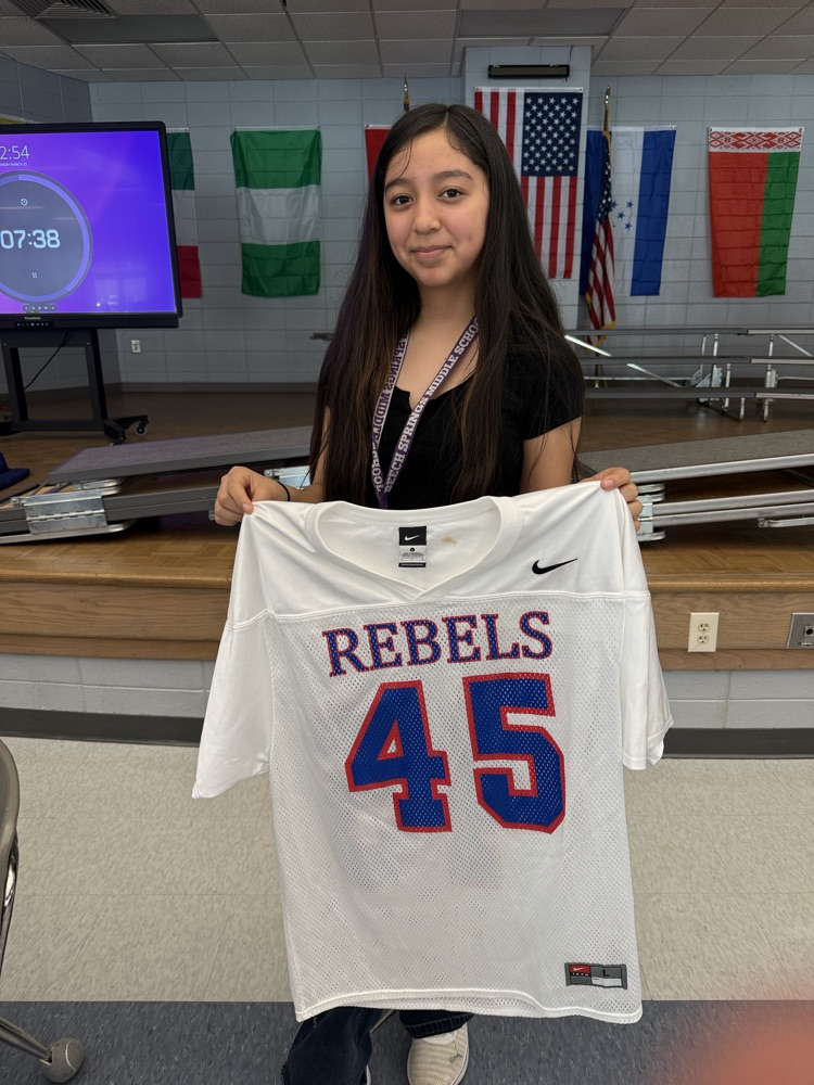 student holding jersey 