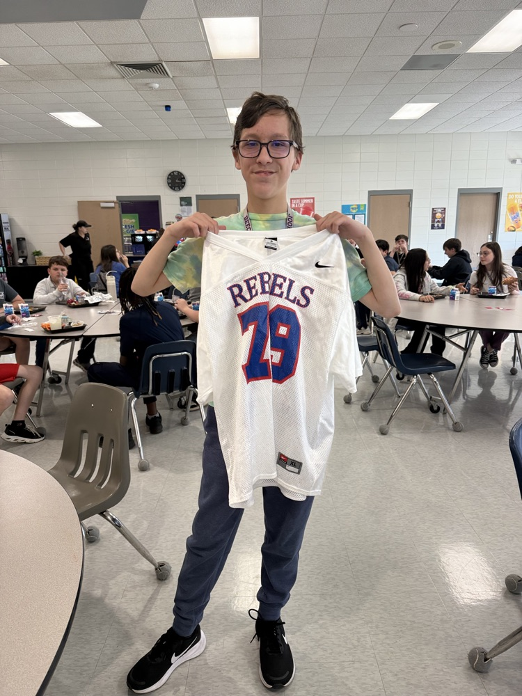 student holding jersey 