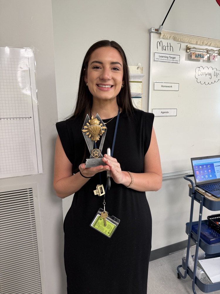 teacher with trophy 
