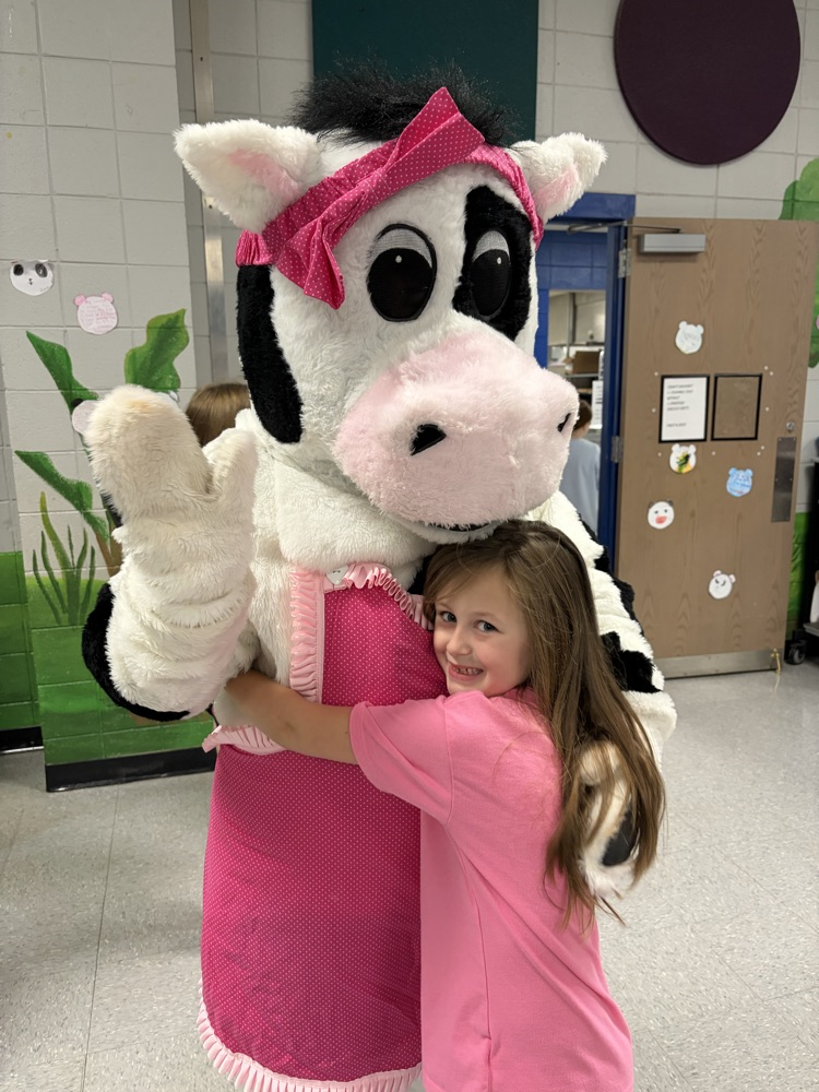 cow mascot in the cafeteria breakfast line 