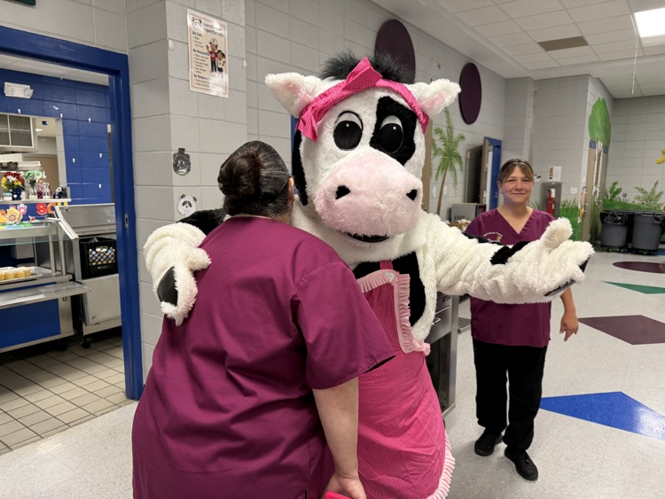 cow mascot in the cafeteria breakfast line