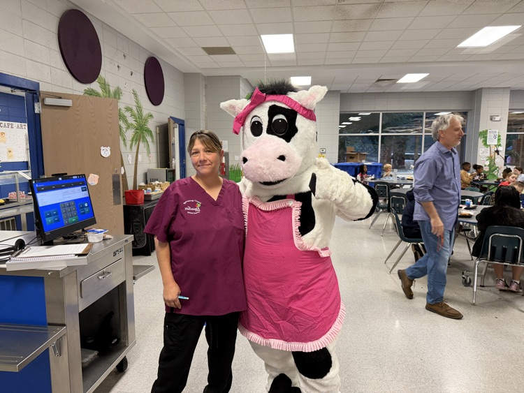 cow mascot in the cafeteria breakfast line