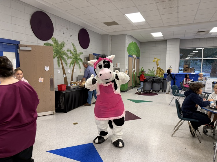 cow mascot in the cafeteria breakfast line