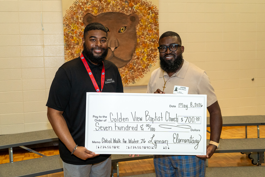 Lyman Elementary School Principal presents check