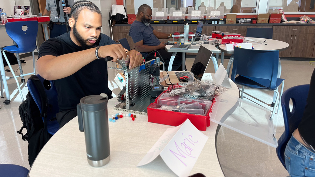 teacher working on conveyer belt