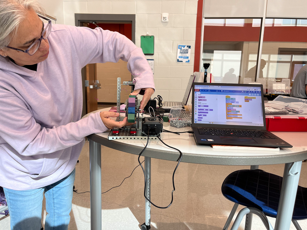 teacher working on conveyer belt