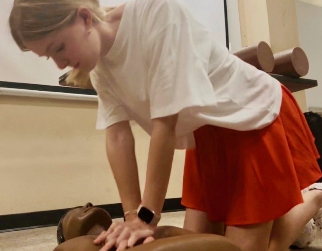 Student practicing CPR on a dummy