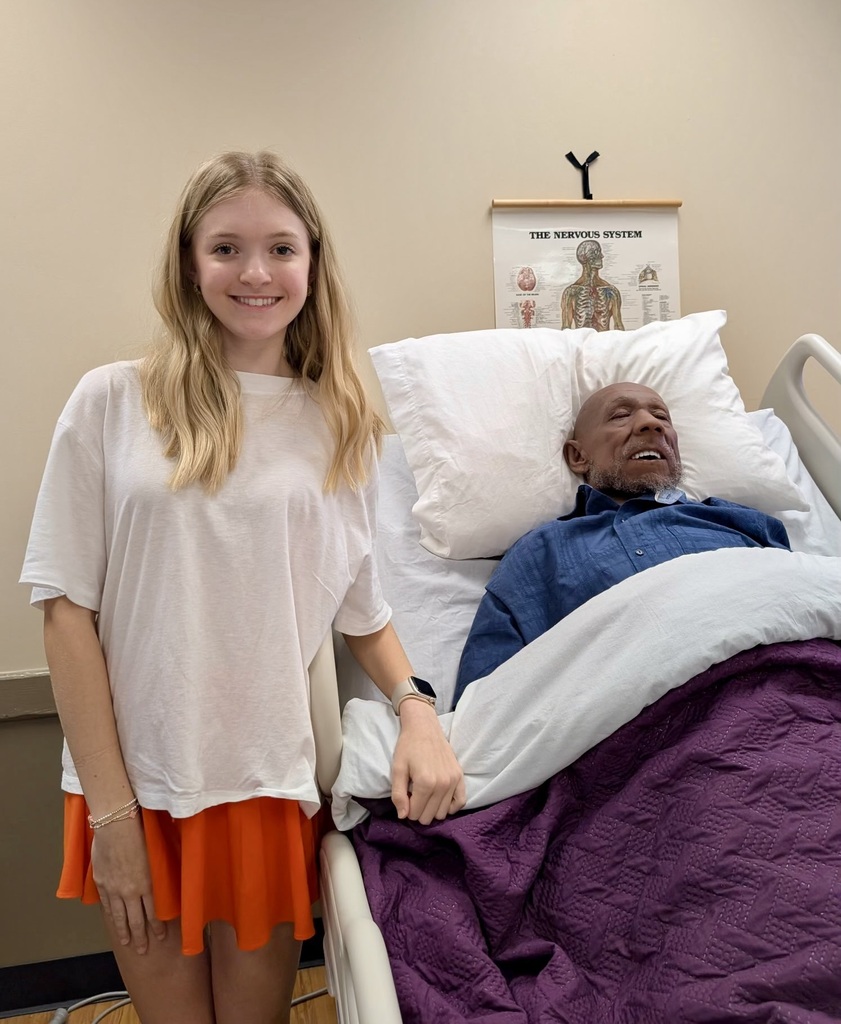Student next to practice mannequin