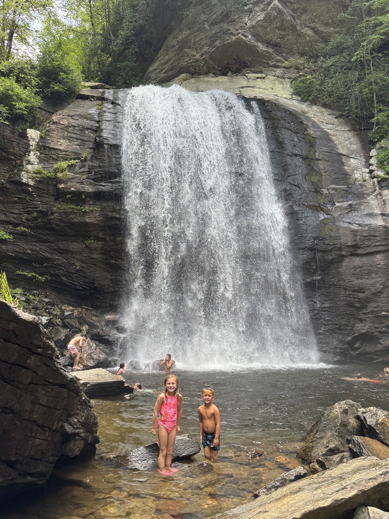 Students posing in front of waterfalls