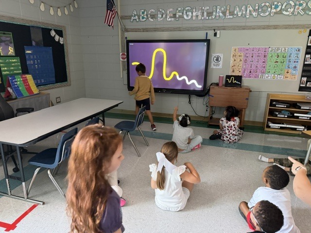 children working and playing in a classroom