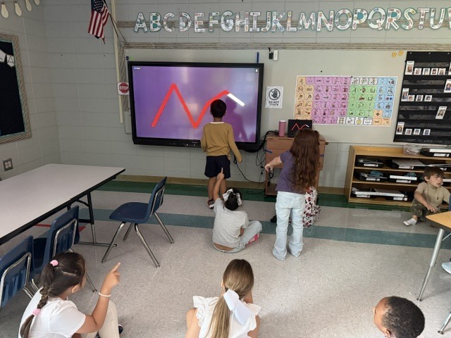 children working and playing in a classroom