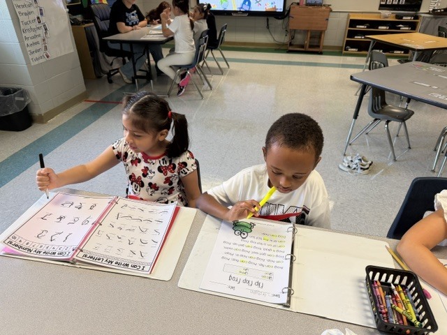children working and playing in a classroom