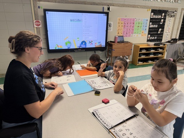 children working and playing in a classroom