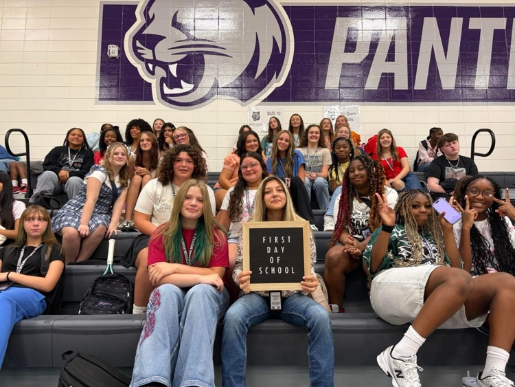 students sitting on bleachers