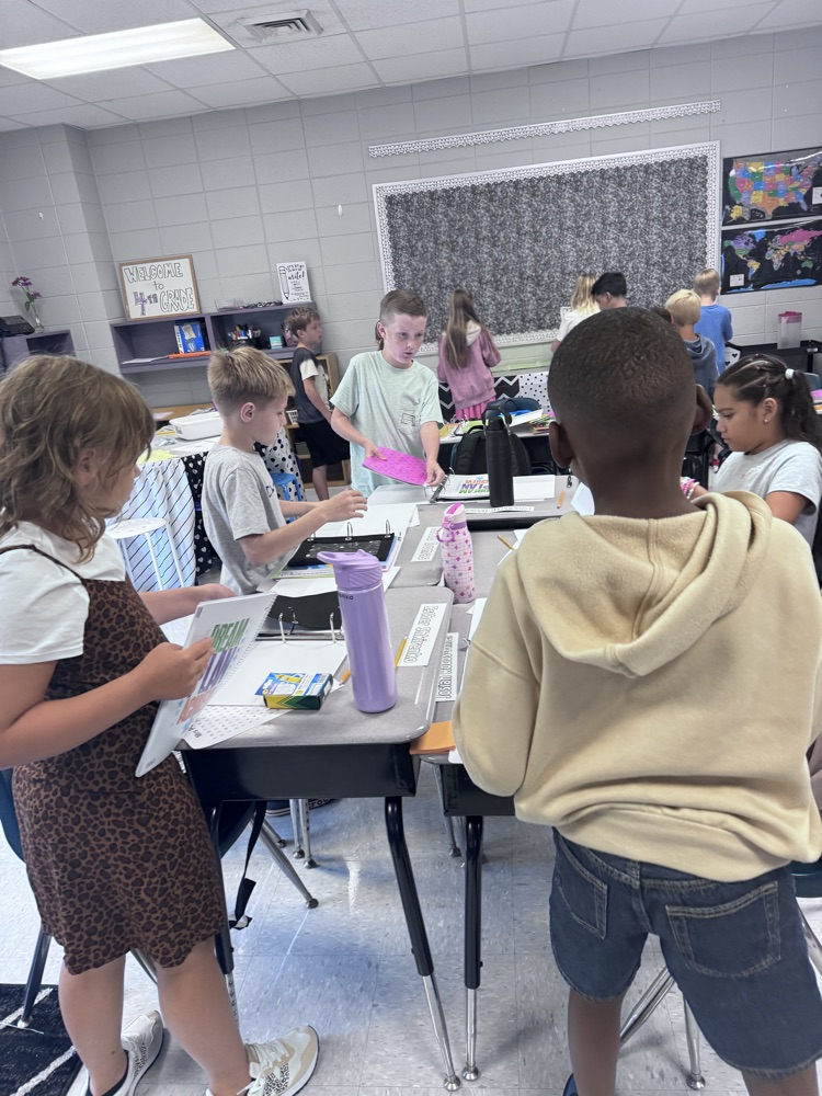 4th graders working together on a group project in the classroom