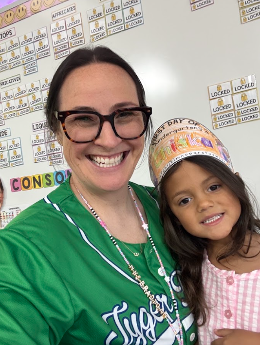 This image includes a picture of Mrs. Bradigan with a student.