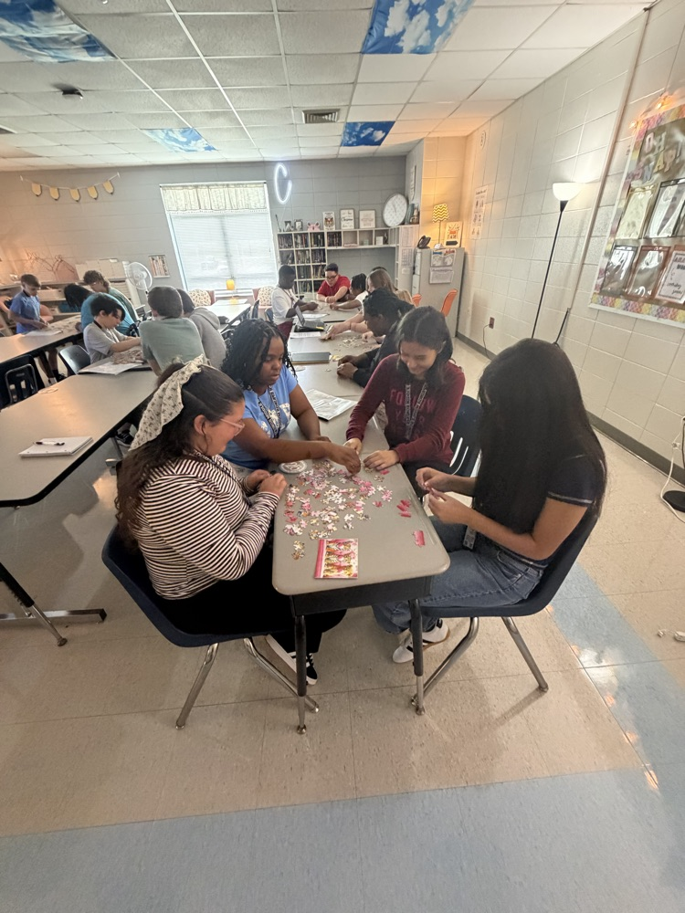 group of students working on a puzzle