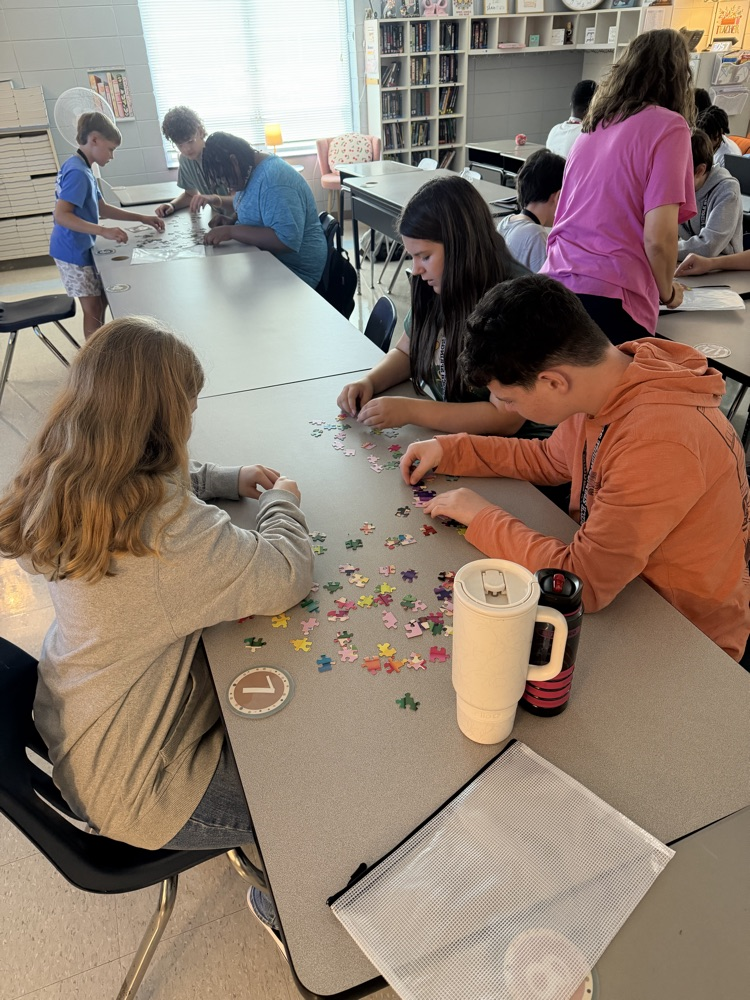 group of students working on a puzzle