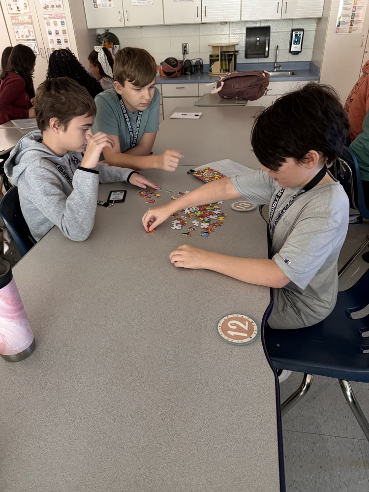 group of students working on a puzzle