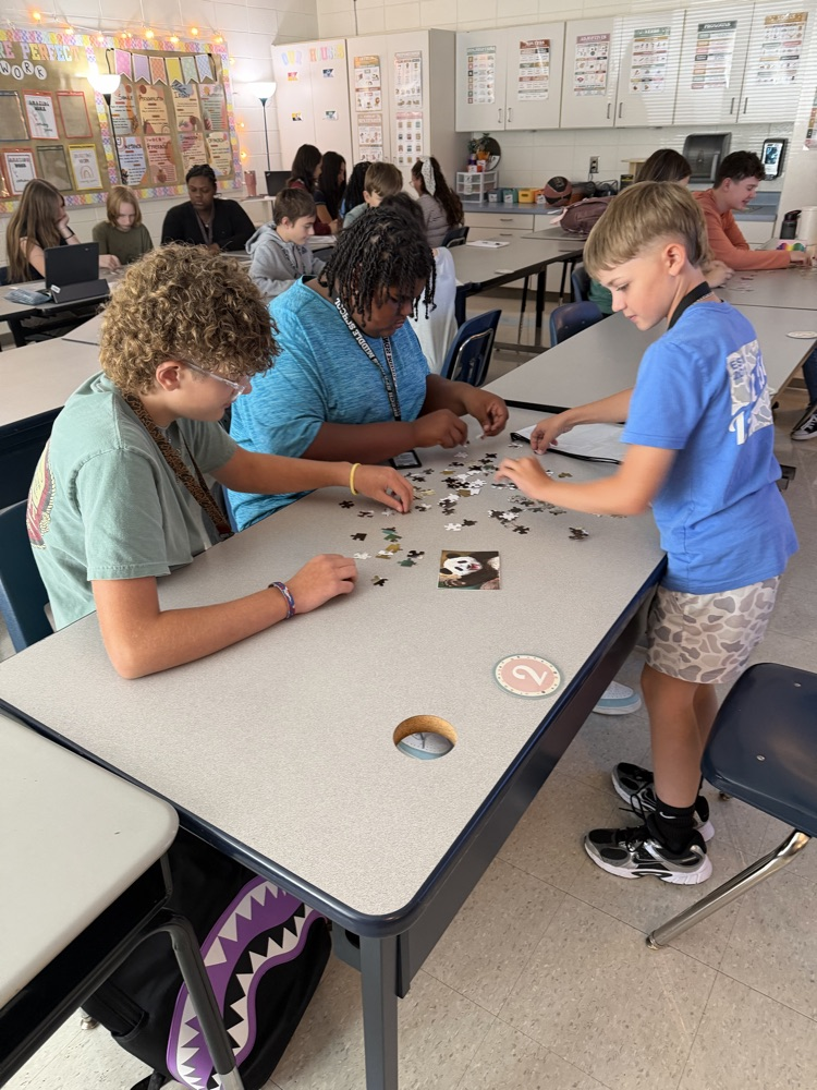 group of students working on a puzzle