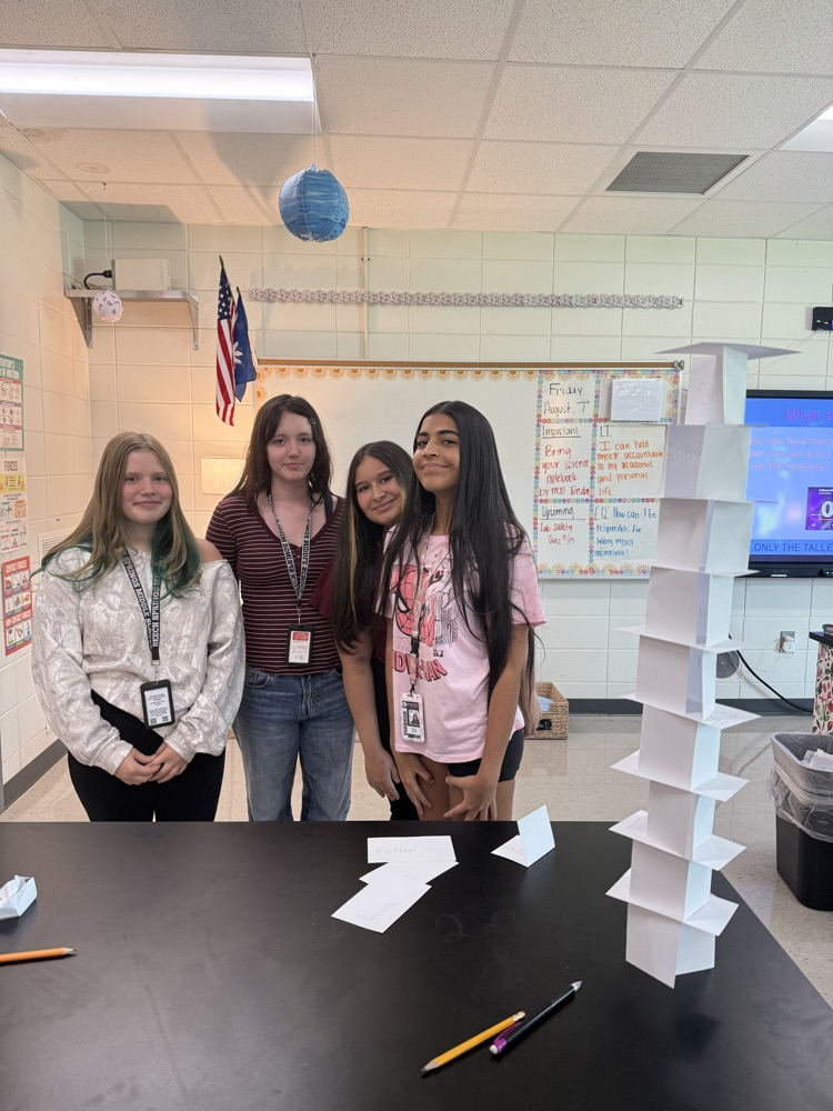 4 students smiling together