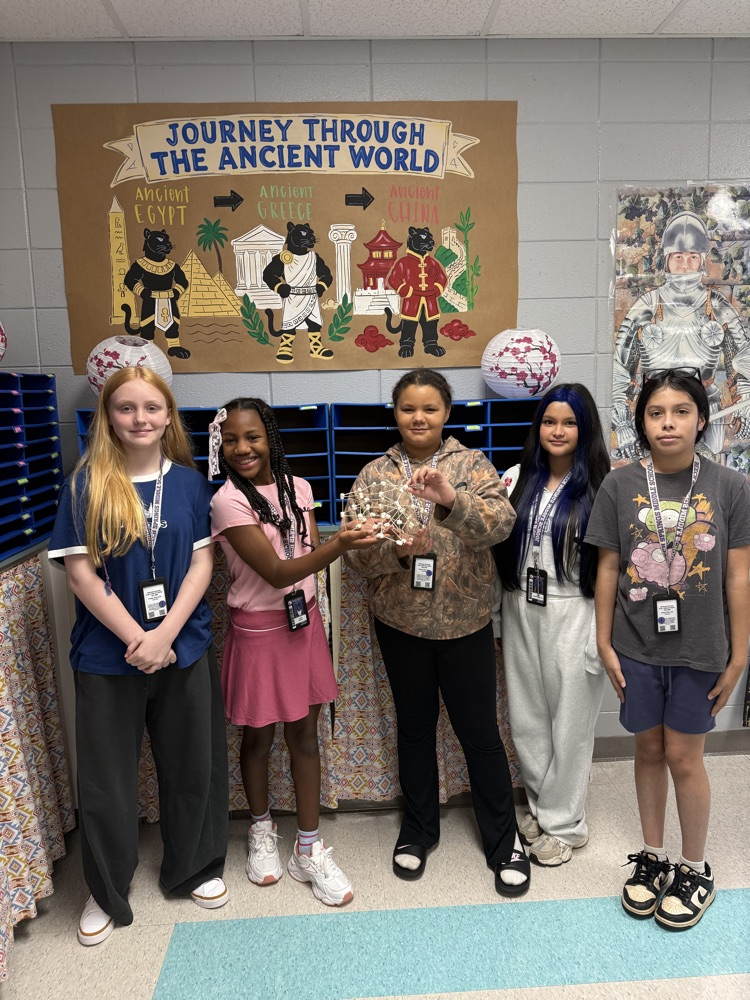 students posing with their work