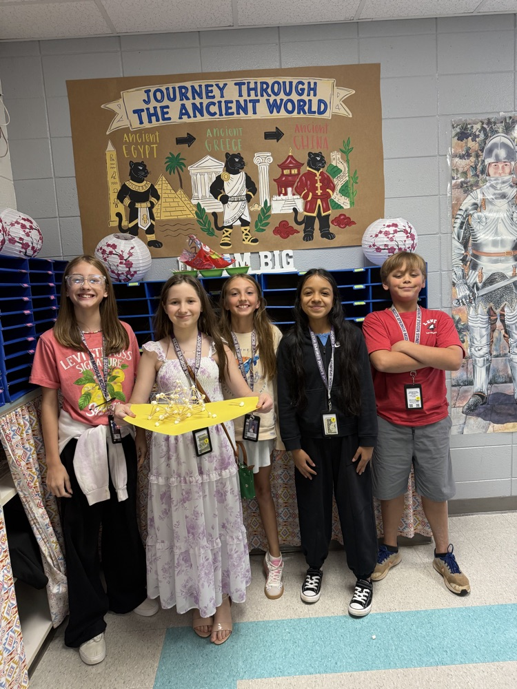 students posing with their tower