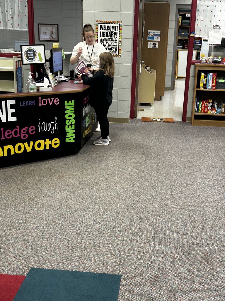 students in the library finding books