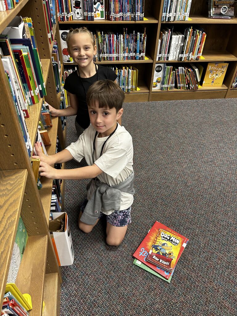students in the library finding books