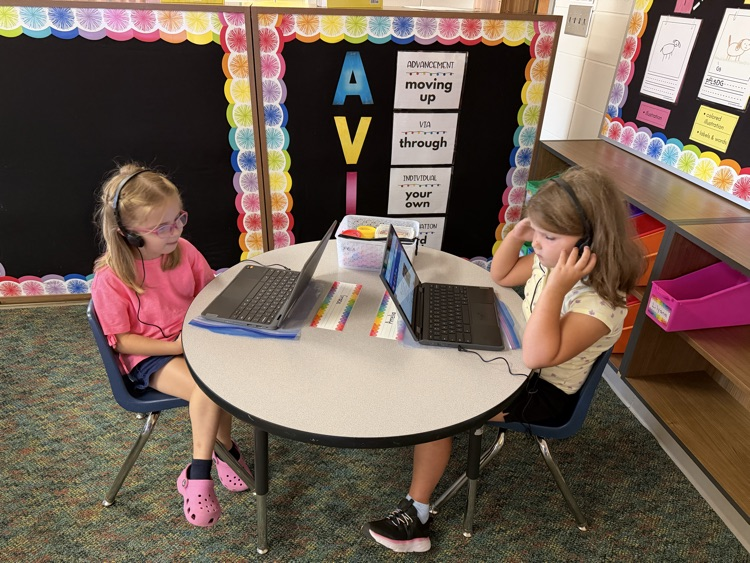 students learning how to use a computer
