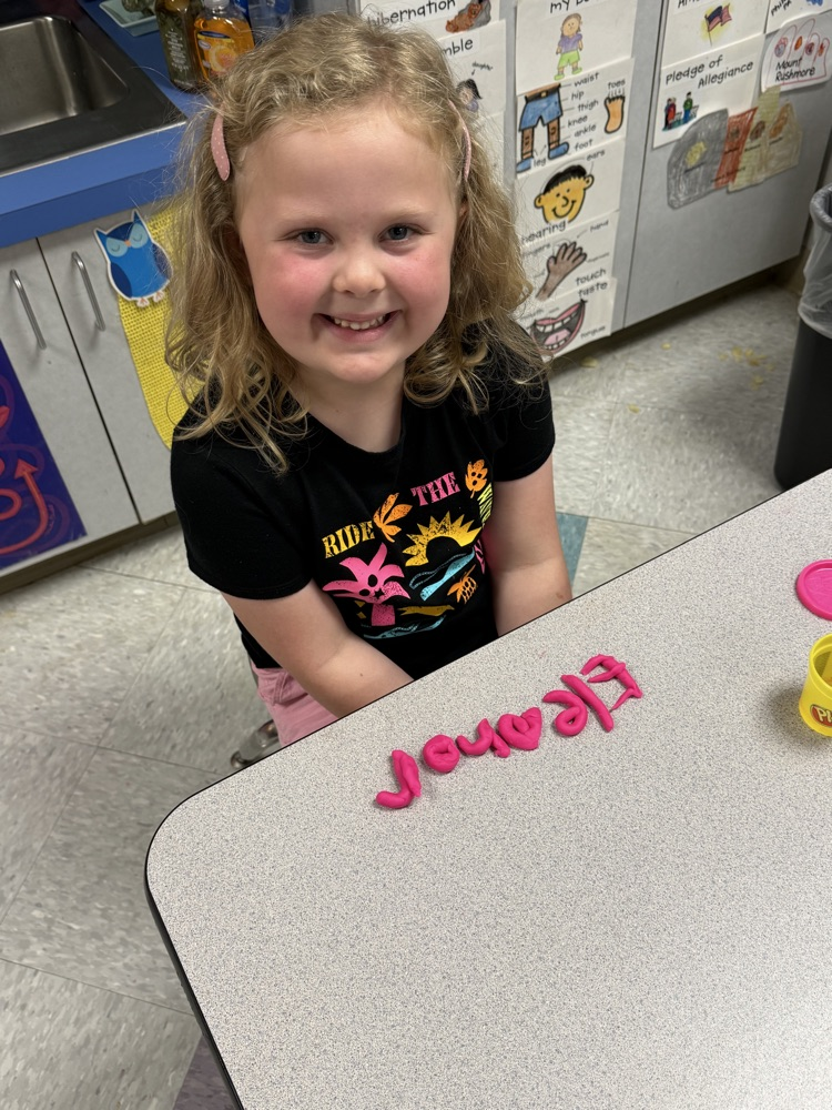 students making names with playdough 