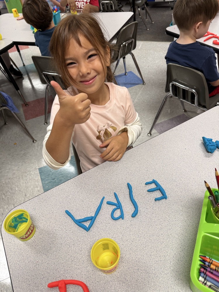 students making names with playdough 